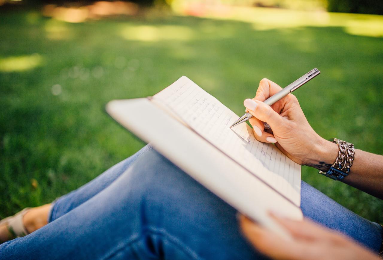 girl writing on a notebook