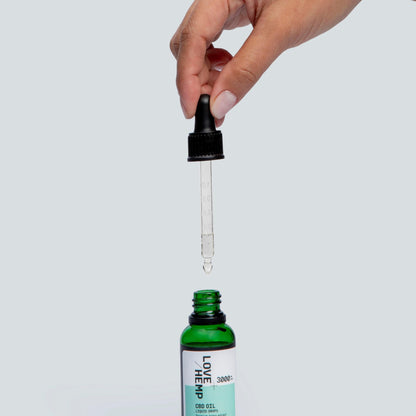 hand holding droplet of CBD Oil Drops 3000mg natural