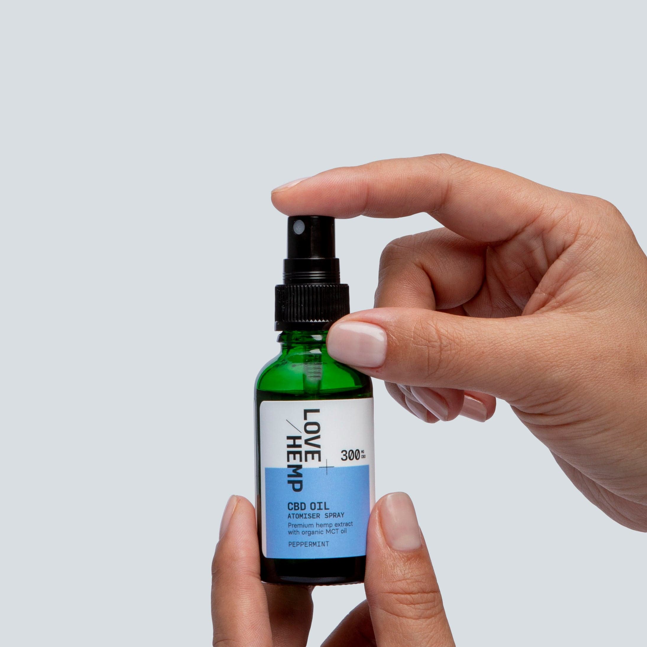 hand holding CBD Oil Spray 300mg peppermint