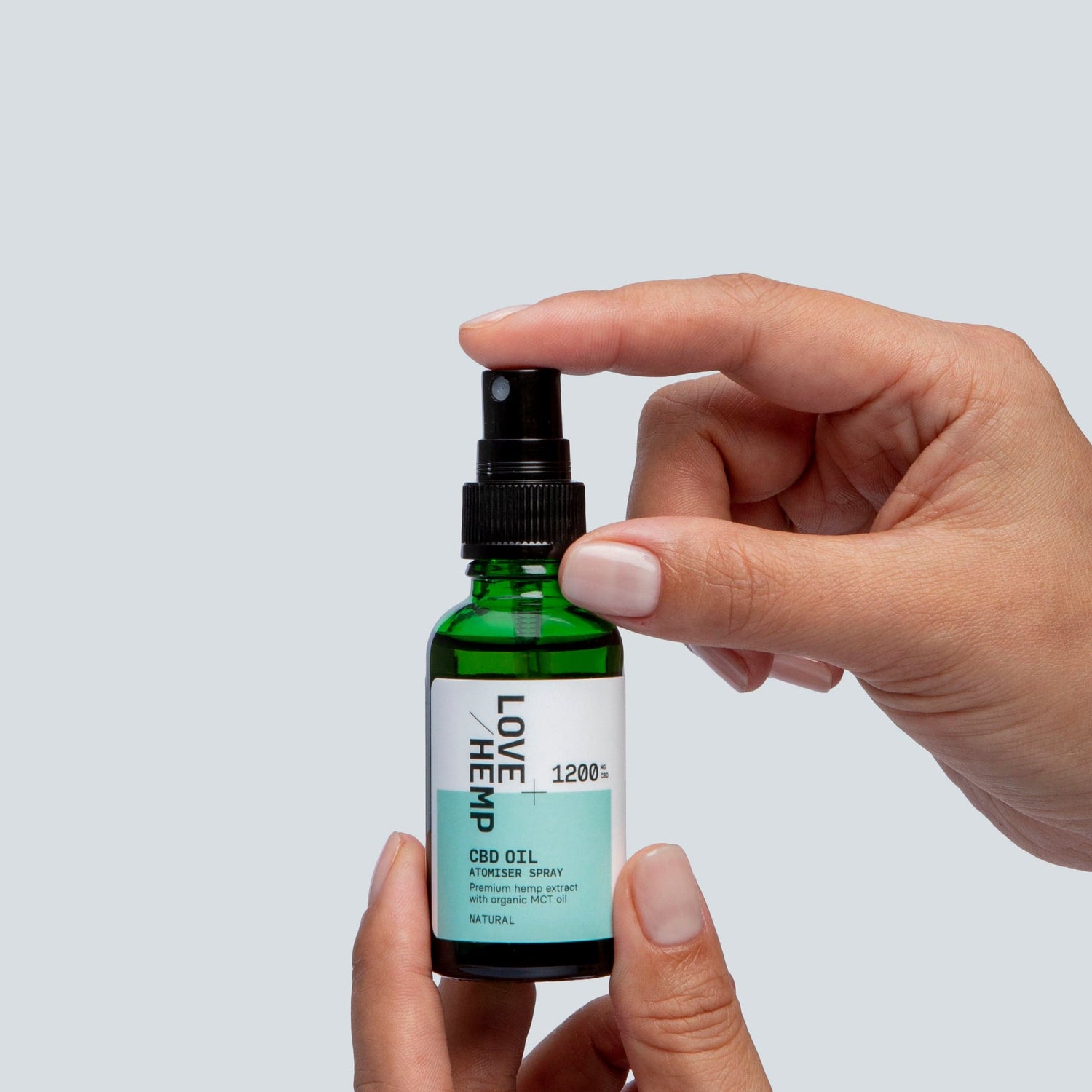 hand holding CBD Oil Spray 1200mg natural