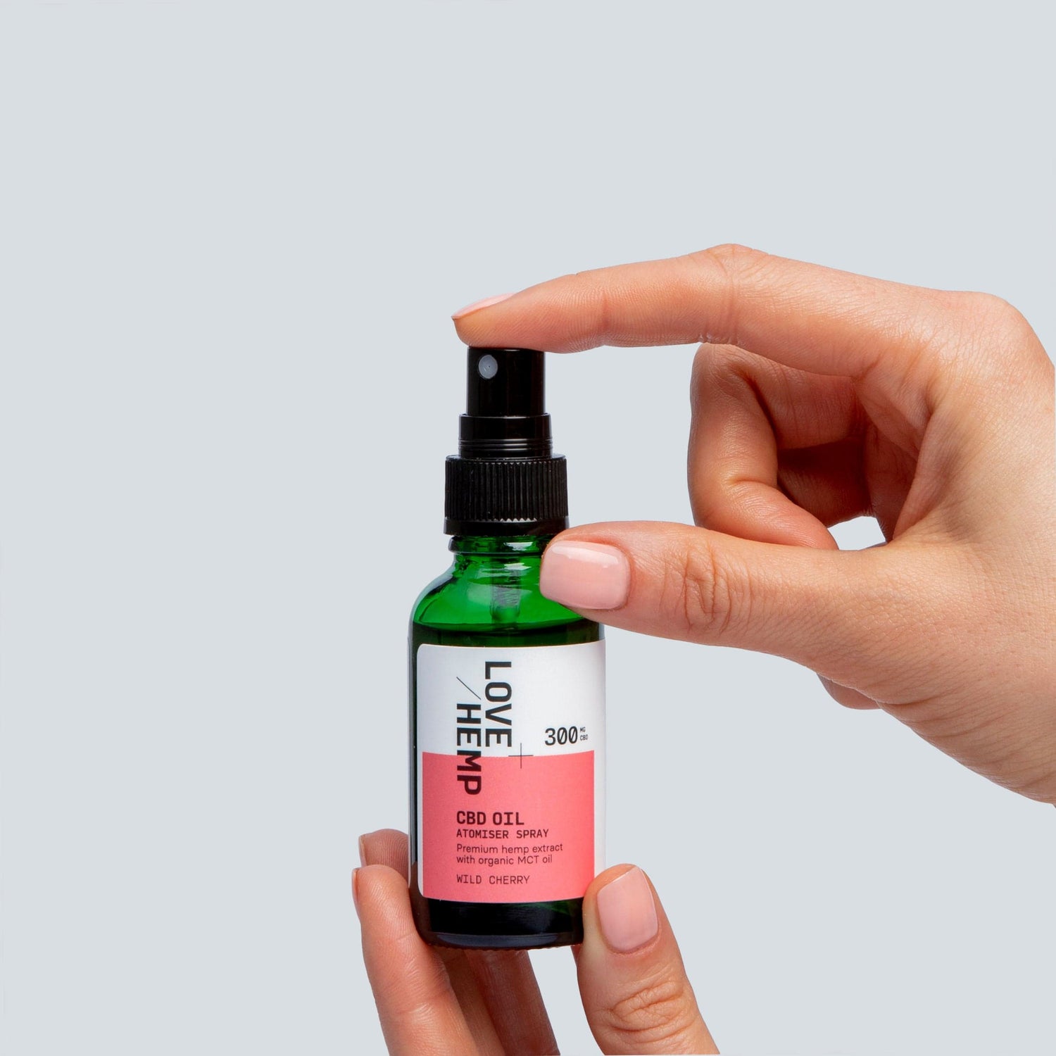 hand holding CBD Oil Spray 300mg wild cherry