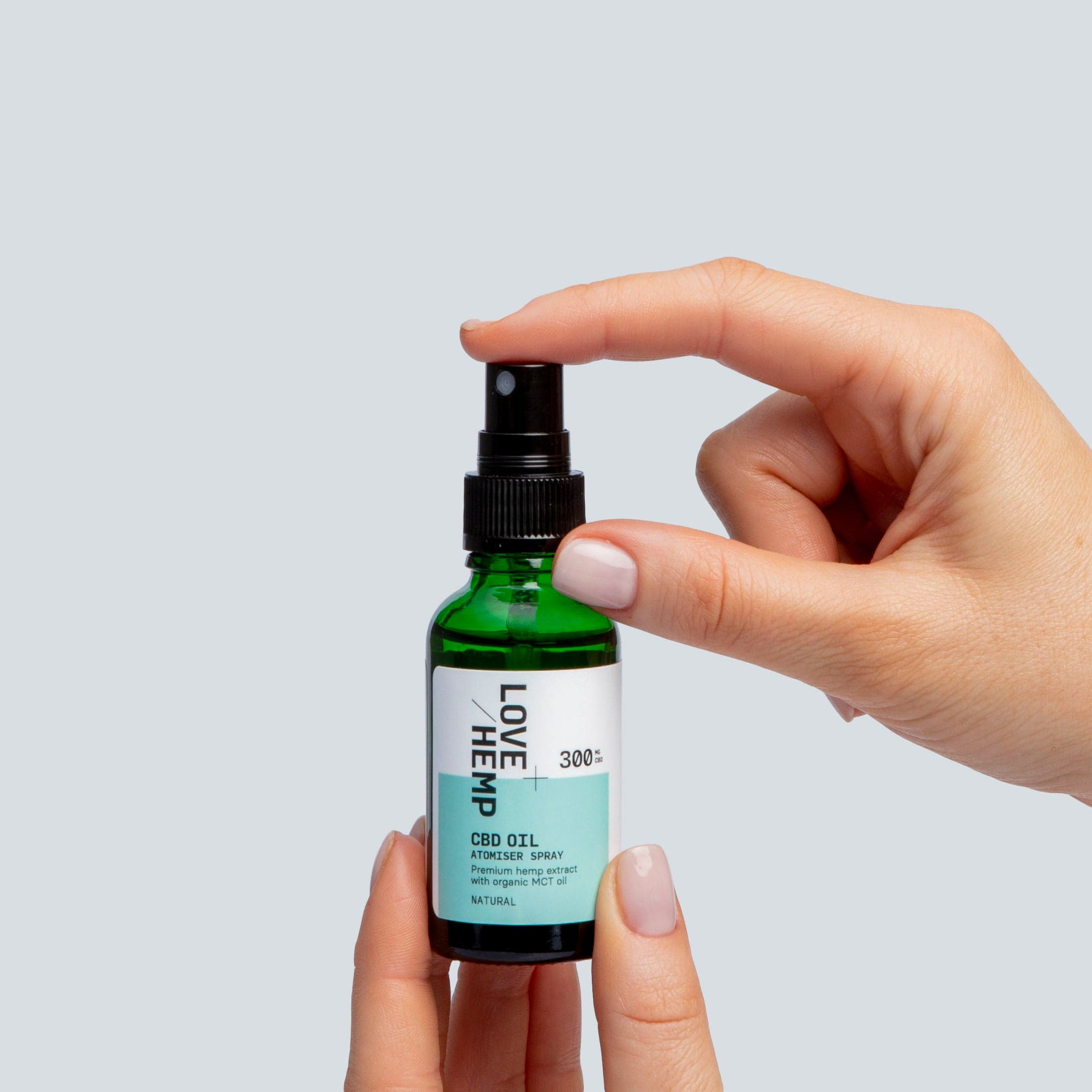 hand holding CBD Oil Spray 300mg natural