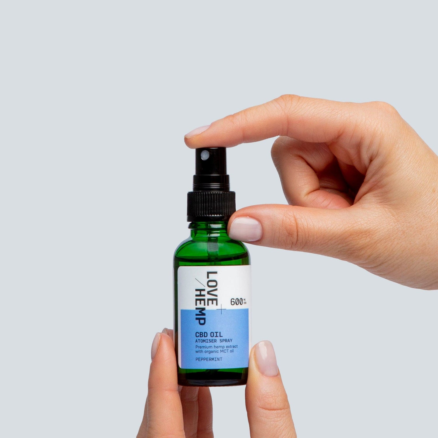 hand holding CBD Oil Atomiser Spray 600mg peppermint